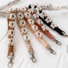 four lanyards are lined up on a white surface