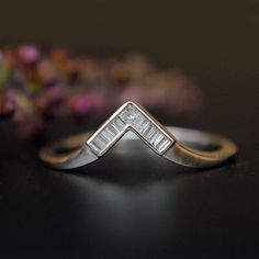 "This simple and gorgeous art deco V ring is crafted in 14k gold with 1 princess cut diamond at the tip and baguette diamonds forming the V. The diamonds are securely held in a clean channel setting. This wedding ring will be a snug fit for any engagement ring! * Diamond Wt. : 0.08 Cts (Baguette) + 0.03 ct (Princess) * Color-Clarity Grade : G-H, Vs-Si * Gold - 14kt, solid white gold (other options available) If you like this ring, please press \"Pin it\" button on the right of your screen. Find Art Deco Diamond Ring With Baguette Diamonds, Art Deco Wedding Ring With Baguette Diamonds, Art Deco Silver Ring With Baguette Diamonds, Art Deco Silver Rings With Baguette Diamonds, Silver Art Deco Rings With Baguette Diamonds, Wedding 14k White Gold Diamond Ring With Baguettes, 14k White Gold Wedding Ring With Baguette Diamonds, 14k White Gold Baguette Diamond Wedding Jewelry, 14k White Gold Baguette Diamond Wedding Ring