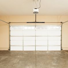 an empty garage with two overhead lights on the ceiling