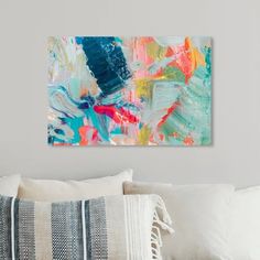 an abstract painting on the wall above a couch