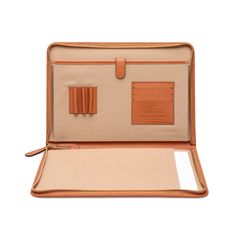 an open tan briefcase on a white background