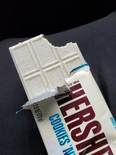 a bar of white chocolate sitting on top of a black surface