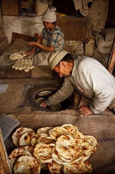 two men working in an open market selling food