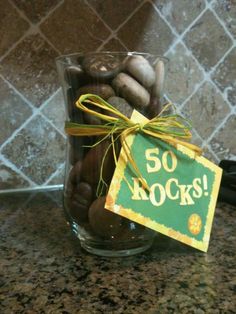 a glass vase filled with rocks and a sign that says 50 rocks on the side