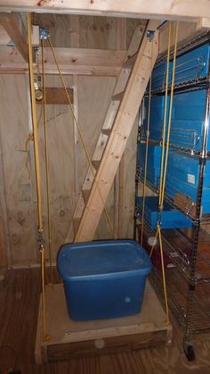 the room is filled with blue containers and shelves