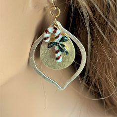 The holidays will be here soon, and you will be ready for the parties wearing these elegant gold candy cane earrings!  Red, white and green candy cane charms hang inside teardrop shaped brushed gold dangles.  The 2.5-inch holiday earrings are pretty and lightweight.  The pretty earrings dangle from gold filled ear wires. These earrings are handmade by me, Sharon, of Blonde Peach Jewelry. They will arrive in an attractive organza bag that is great for storage and gift giving. Feel free to contact Handmade Holiday Jewelry, Candy Cane Earrings, Pretty Earrings Dangle, Beachy Earrings, Colorful Choker, Green Candy Canes, Peach Jewelry, Gold Candy, Green Charms