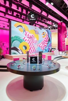 a large display in the middle of a room with pink walls and white flooring