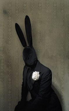 a person in a suit and bunny ears