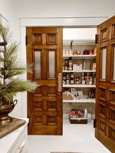 an open door leading to a pantry with spices and other items on the shelves next to it