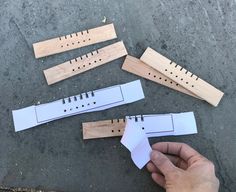 four pieces of wood are cut out to look like rulers