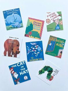 several children's books laid out on top of a white surface, including the cat in the hat