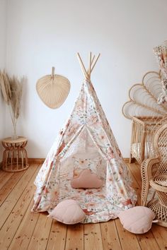 a teepee with flowers on it in a room