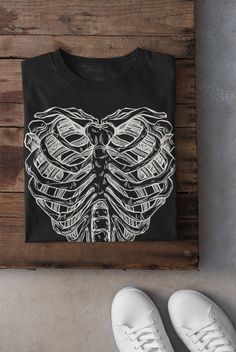 Thanks for stopping by! Ribs and Moths T-shirt Printed on a super soft, cotton tee Dispatched in 5 working days or sooner Unisex Free UK delivery Material: 100% ringspun cotton. Chest (to fit): S  34/36   M  38   L  40/42   XL  44/46   XXL  48/50 ECO-FRIENDLY Each garment is made to order, reducing extra material and energy that would be otherwise wasted We use DTG printing process which is easier on the environment than screen-printing Our ink is bright and also eco-friendly. Do not tumble dry. White Emo Style Crew Neck T-shirt, White Emo Tops With Screen Print, White Emo Crew Neck T-shirt, White Emo Style T-shirt With Graphic Print, Emo Style Pre-shrunk Short Sleeve T-shirt, White Emo T-shirt For Alternative Fashion, Emo Crew Neck T-shirt For Halloween, White Emo T-shirt With Graphic Print, Emo Graphic Print T-shirt For Alternative Fashion