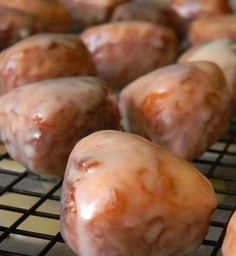 glazed donuts on a cooling rack ready to be baked in the oven for consumption