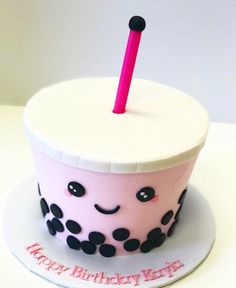 a birthday cupcake with a pink candle sticking out of it