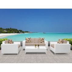 an outdoor patio furniture set with blue water in the background