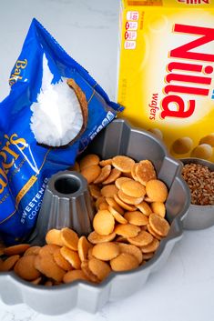 a bowl filled with almonds next to a bag of floured sugar and other ingredients