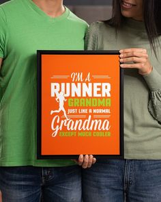 two people holding up a framed sign that says i'm a runner, just like a normal grandma