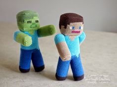 two crocheted toy figures are standing next to each other