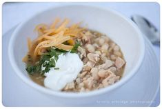 a white bowl filled with beans and cheese