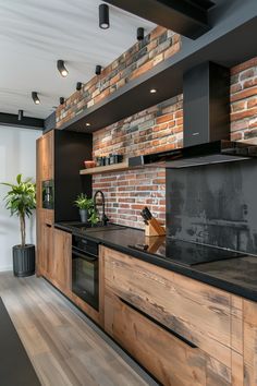 a modern kitchen with brick wall and wooden counter tops, along with black appliances in the center