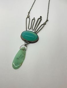 "This piece has MOXY  ....necklace style featuring this lush glow seafoam blue green vintage glass piece & epic chrsoprase dropwith eclectic metalwork detailsthis necklace will not disappoint!! made with oxidized sterling silver and vintage glass 3.25\" x 1.5\" x .25\".  this piece is handmade by me from start to finish in my studio in austin, texas. the piece is constructed of sterling silver, soldered, sanded, filed, hand set stone, oxidized, and sanded again and features a handmade clasp and is signed on the back.  due to the handmade nature of this piece there may be subtle differences between the piece pictured and the piece especially made from you.  please specify the length of chain you prefer in the notes to seller section. thanks for looking enjoy your awesome day **pieces will b Unique Turquoise Chrysoprase Jewelry, Handmade Modern Green Jewelry, Modern Handmade Green Jewelry, Green Handmade Modern Jewelry, Modern Green Handmade Jewelry, Modern Green Cabochon Jewelry, Modern Green Pendant Jewelry, Vintage Green Jewelry With Unique Variations, One-of-a-kind Green Chrysoprase Necklace