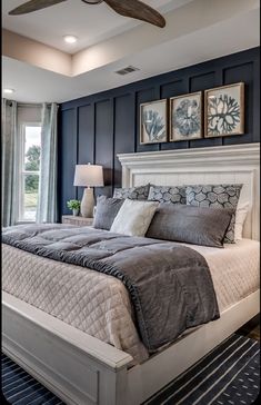 a bedroom with a large bed and ceiling fan