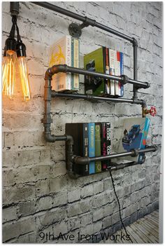 a light that is on the side of a brick wall next to bookshelves