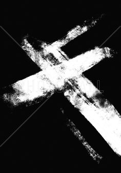 a black and white photo of a cross in the middle of it's image