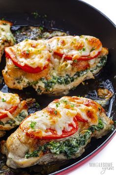 chicken with tomatoes and spinach in a skillet