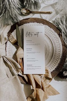 a table setting with napkins, silverware and place settings for an elegant dinner