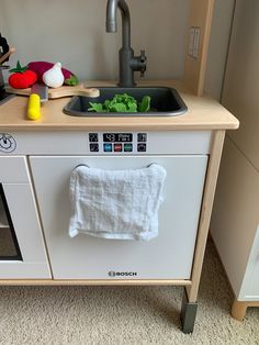 a kitchen sink with a towel hanging from the faucet