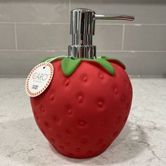 a soap dispenser shaped like a strawberry