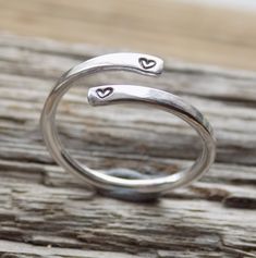 Made form 1.8 mm thick sterling silver wire. Slightly flattened at each end of the ring and stamped with tiny hearts. This ring can be adjusted slightly for a perfect fit.     MADE TO ORDER - type required size into the options box. Please allow up to an extra week on top of delivery times.   Presented in a stamped W and F gift tin  Sent via first class post.    marked with a 925 silver punch. Handmade Silver Jewellery Rings, Silver Ring Making Ideas, Ear Cuff Diy, Handmade Silver Rings, Wrap Around Ring, Copper Jewellery, Handmade Silver Jewellery, Vintage Cutlery, Handmade Stuff