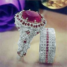 two rings with red and white stones on them