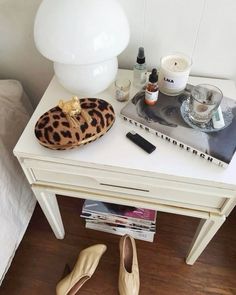 there is a pair of shoes on the table next to some magazines and other items