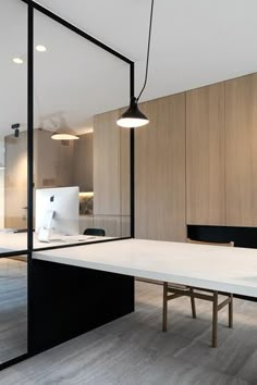 an office with a white table and black chairs