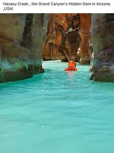 a person in an orange kayak floating through a canyon