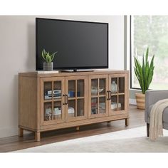 an entertainment center in a living room with a flat screen tv