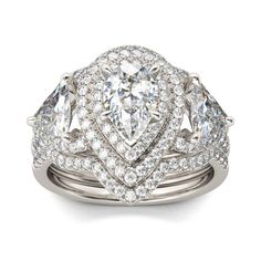 This magnificent design is centered with a sparkling pear-cut stone wrapped in double halo frames of round stones. Trillion stones flank each side while additional stones line the shank. On your wedding day, the coordinating wedding band fits closely with the engagement ring, completing the ensemble. This set is destined to delight.Carat Weight: 1.99 ctStone Size: 6*9 mmStone Type: Jeulia® StoneNumber of Stones: 1 Stone Color: Diamond WhiteStone Shape: PearCarat Weight: 4.16 ctStone Size: 1.1,1. Silver Pear-shaped Halo Ring For Wedding, Silver Teardrop Wedding Ring With Halo Setting, Pear-shaped Silver Halo Ring For Wedding, White Gold Pear-shaped Halo Wedding Ring, Pear-shaped Halo Ring For Wedding, Pear-shaped White Gold Halo Wedding Ring, Teardrop Halo Diamond Wedding Ring, Teardrop Diamond Halo Ring For Wedding, Wedding Pear-shaped Halo Diamond Ring