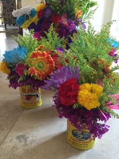 colorful flowers and plants in cans on the floor