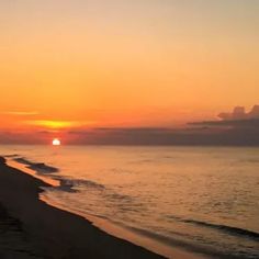 the sun is setting over the water at the beach