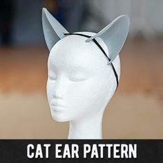 a white mannequin head wearing a cat ears hat