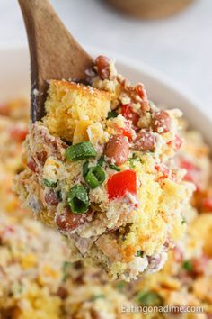 a spoon full of food that is in a bowl