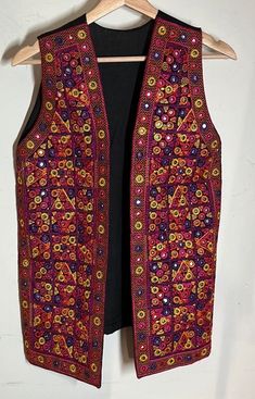 Heavier weight open front vest - Pit to pit 17" / length(shoulder to bottom) 26" / smoke-free environment / no issues / hardly used it at all (W) Embroidered Sleeveless Vest For Festival, Embroidered Festival Vest, Fitted Sleeveless Vest For Festival, Festive Bohemian Sleeveless Vest, Festive Bohemian Vest, Red Vest For Fall Festival, Fitted Bohemian Vest For Festive Occasions, Multicolor Bohemian Vest For Festive Occasions, Bohemian Sleeveless Vest For Festivals