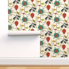 the wall paper is decorated with colorful flowers and leaves on white walls, along with a wooden floor