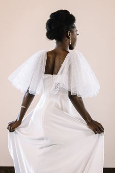 a woman wearing a white dress and veil