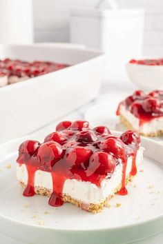 a piece of cheesecake covered in cherries on a plate