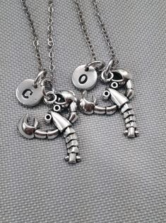 A set of 2 best friend necklaces with lobster charm and hand stamped initial.  Initial charm is 9mm antique pewter - Chain shown 24 inches - Can choose chain length  - Lobster charm is silver plated Lobster Jewelry, Bff Necklace, Necklace Friendship, 2 Best Friends, Jewelry Ocean, Best Friend Necklace, Ocean Necklace, Friendship Necklace, Bff Necklaces