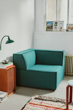 a living room with a blue couch and rug